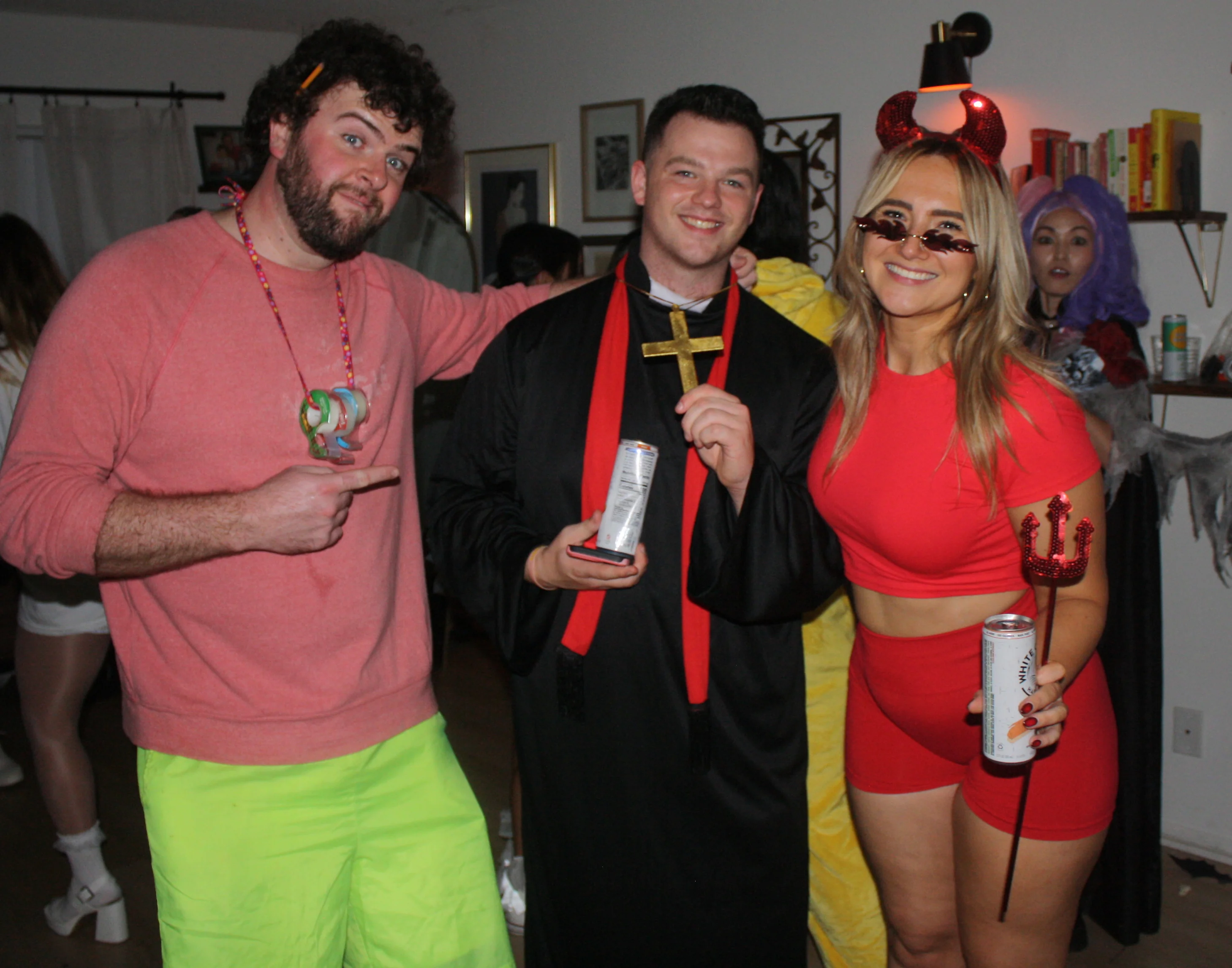 Friends gathered in nun and devil costumes